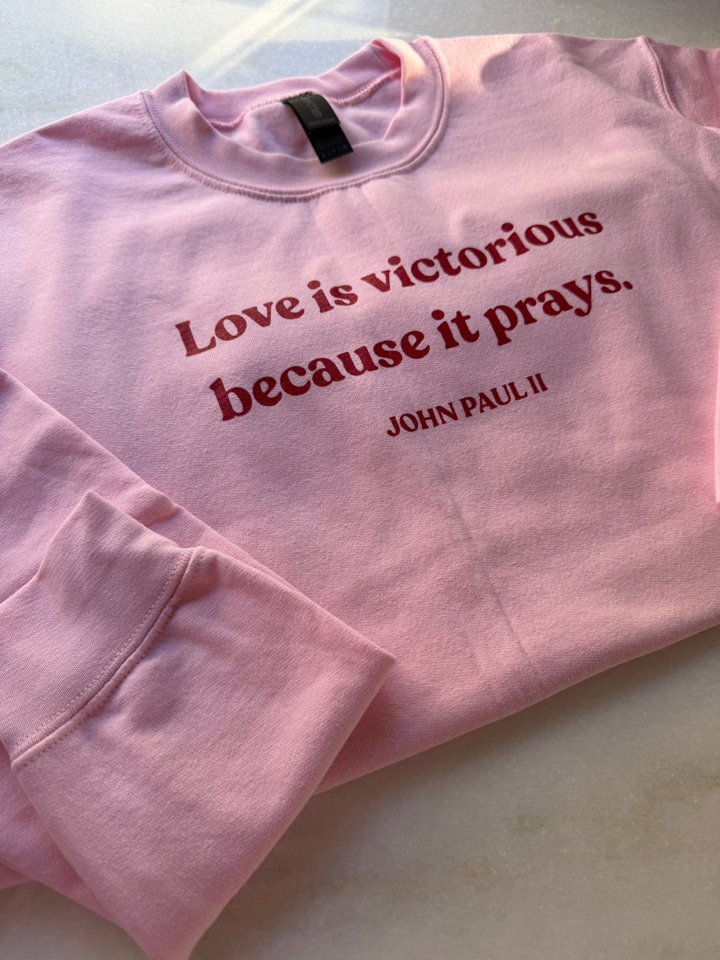 Sweatshirt - "Love is victorious because it prays." John Paul II